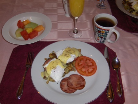 Eggs Benny, rosemary hashbrowns and Canadian bacon.  Fruit, mimosas and hot tea